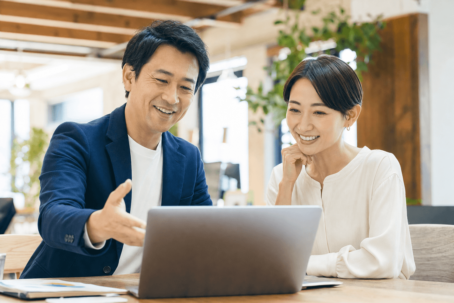 内製化の成果を確認し合う2人のビジネスパーソン